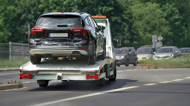 SUV on flatbed tow truck