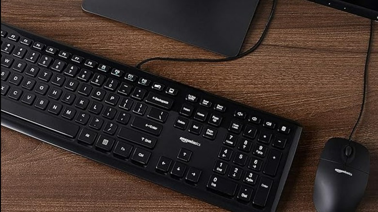 An Amazon Basics mouse and keyboard on a table.