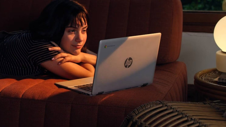 Woman using HP Chromebook on couch