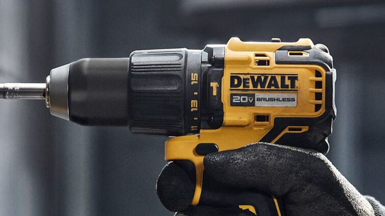 A person using a DeWalt hammer drill