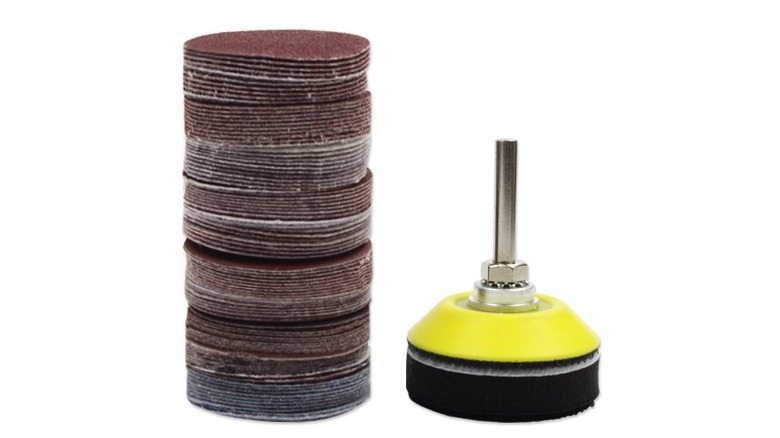 Sanding disk attachment and sandpaper pads on white background