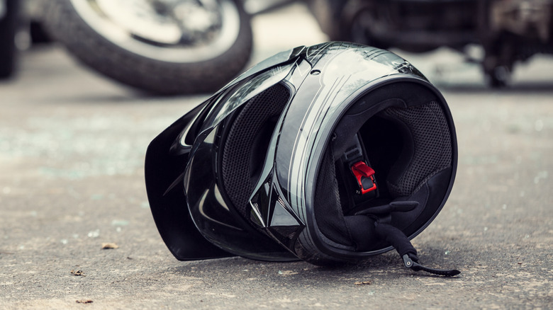 A motor bike helmet lying on the ground