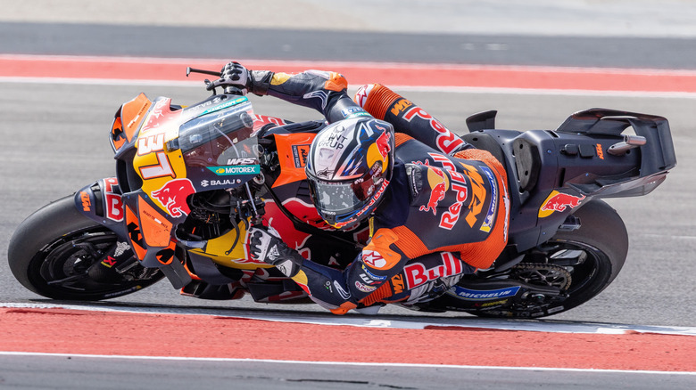 Rider on the Moto GP Red Bull bike leaning hard into a corner