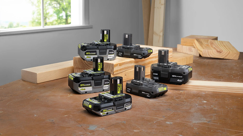 Various Ryobi ONE+ batteries on a floor