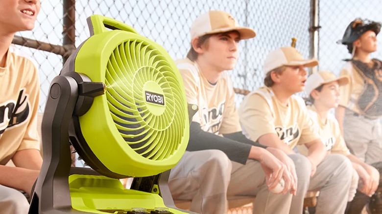 A Ryobi misting fan next to young baseball players