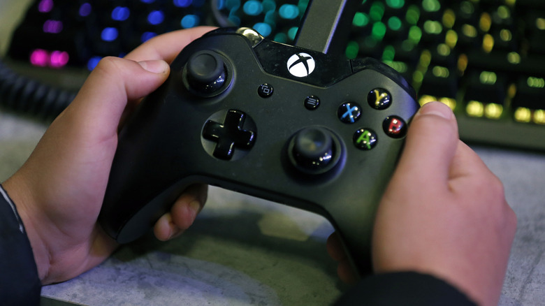 Person holding Xbox controller