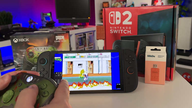 man playing on switch 2 with xbox adapter