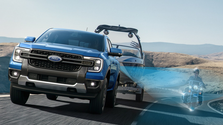 2024 Ford Ranger truck with blind spot system diagram detecting a motorcycle next to it on the road