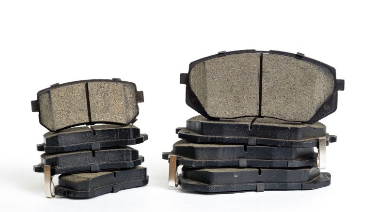 a picture of smaller (rear) brake pads next to larger (front) brake pads