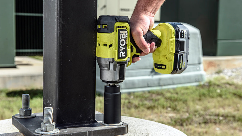 A person using a Ryobi ONE+ Impact Wrench.