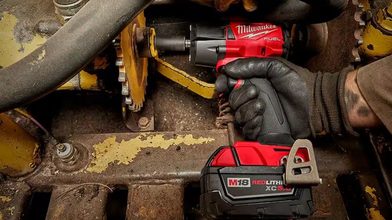 Person using a Milwaukee M18 Fuel impact wrench