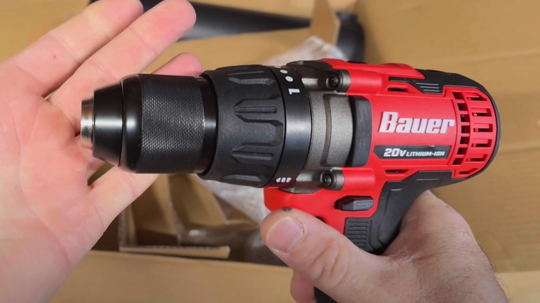 A person holding a Bauer drill.