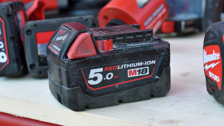 A Milwaukee M18 battery on its side.