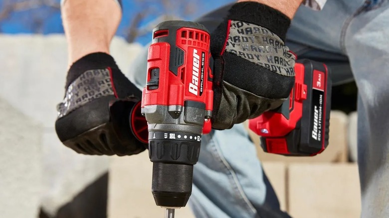A person using a Bauer 20V hammer drill from Harbor Freight.