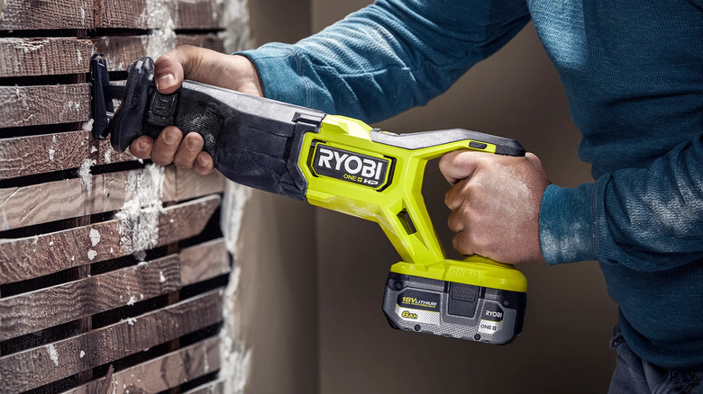 A Ryobi ONE+ reciprocating saw in a wall