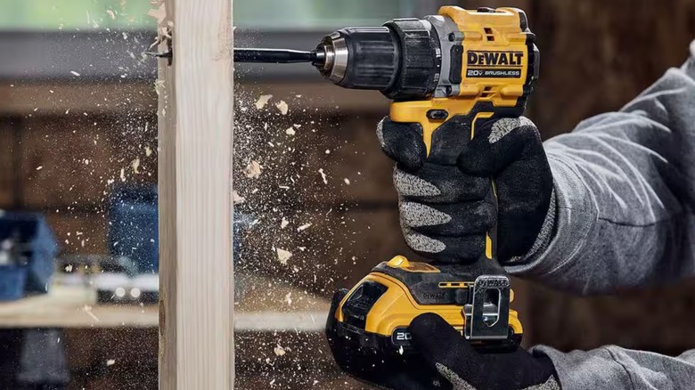 A person using a 20V DeWalt MAX drill driver