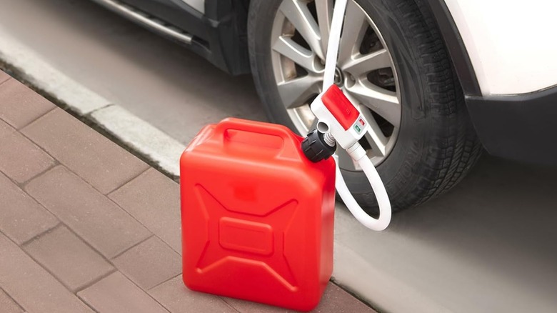 A feedron fuel pump being used to suck fuel out of a car
