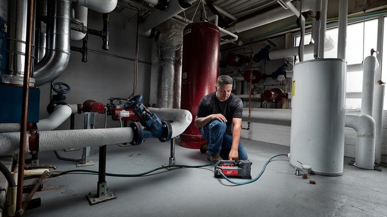 A person using the milwaukee m18 transfer pump