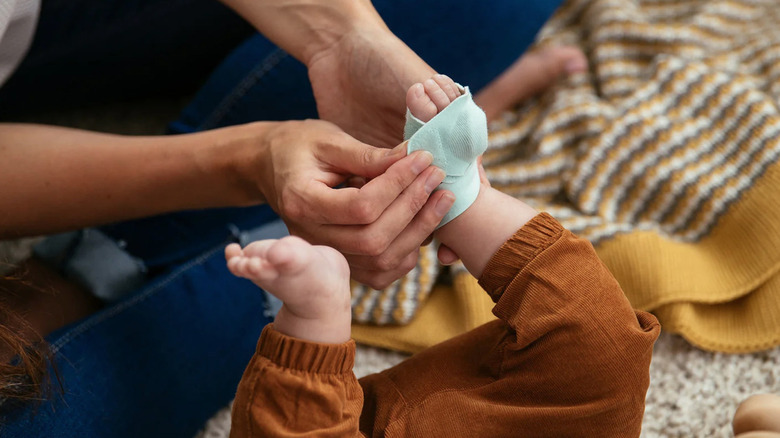 Person putting Smart Sock 2 onto a baby's foot