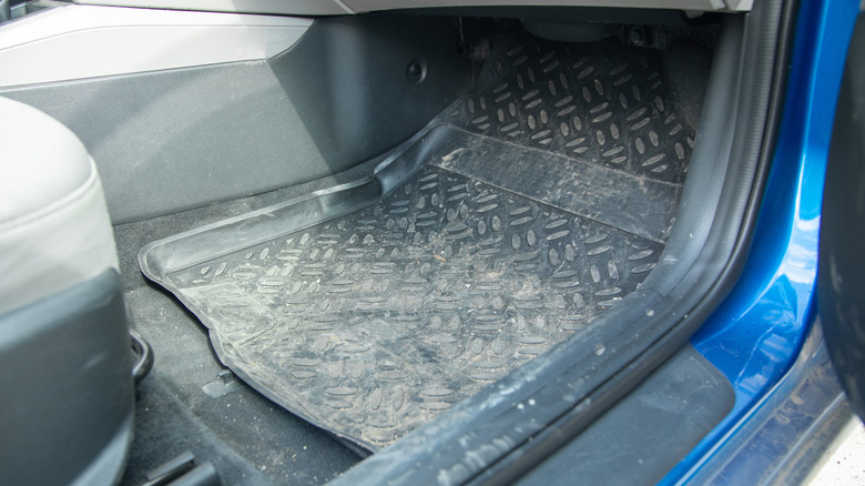 A dirty rubber mat in a car.