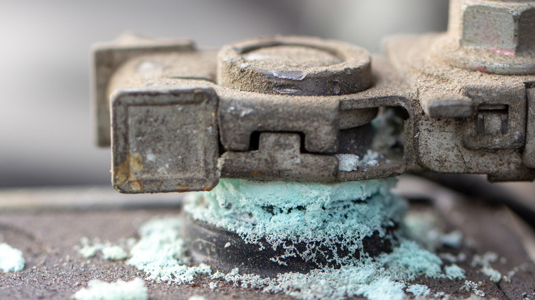 An old car battery leaking from the terminal.