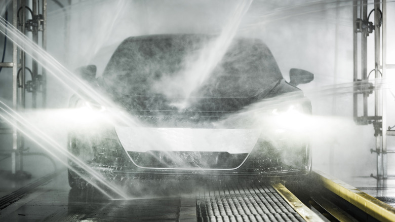 A car goes through a touchless car wash