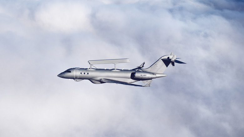 Saab GlobalEye aircraft flying above clouds