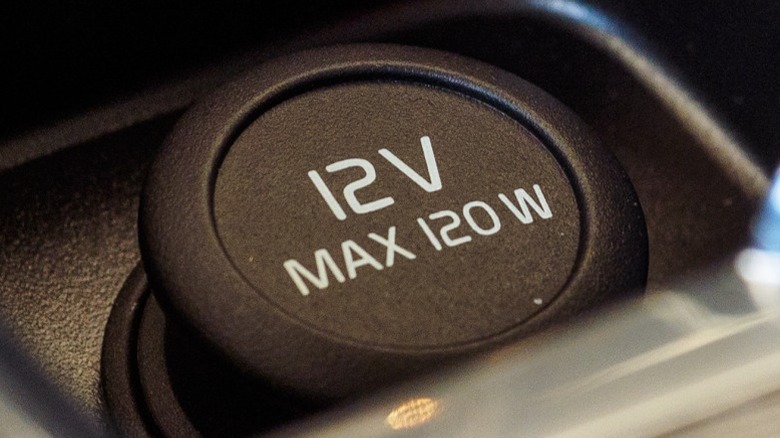 Close up of 12V plug cover in car