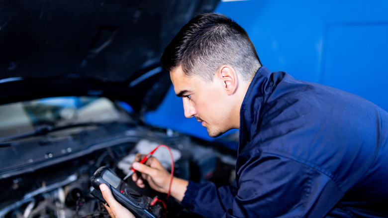 man testing car battery