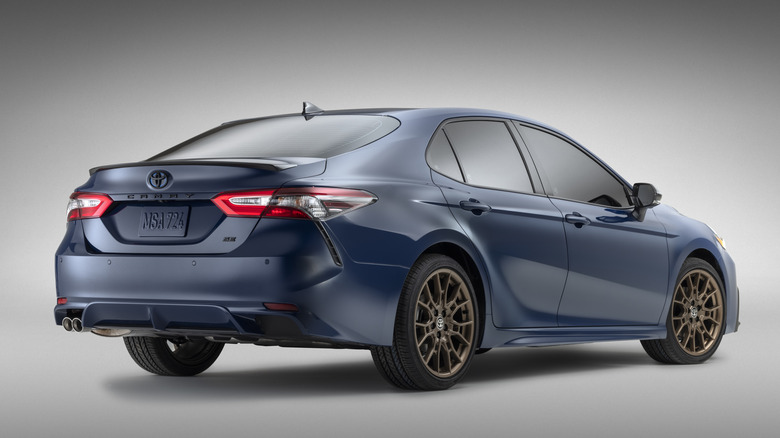 Rear view of  blue 2023 Toyota Camry in studio