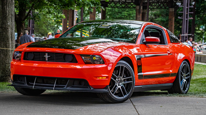 A red Ford Mustang Boss 302 S197 2012 model at a local car show