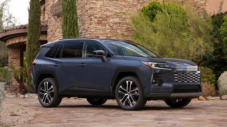 Toyota RAV4 parked in front of a stone building.