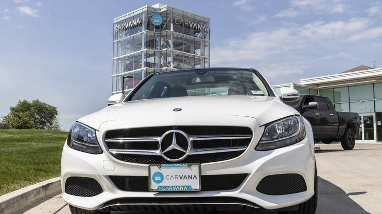 Cars parked in front of a Carvana vending machine.