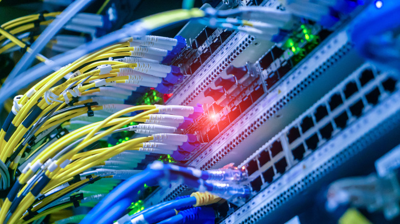 A detailed close-up view of network cables and switches featuring LED indicators.