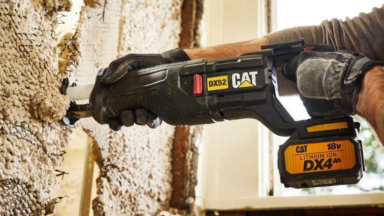 person using Cat 18V Cordless Reciprocating Saw