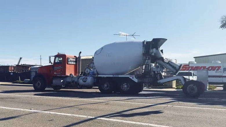 A cement truck with its tag axle down.
