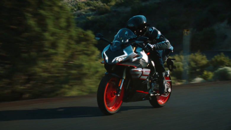 Man riding the new 2026 CFMoto 450SR, front 3/4 view