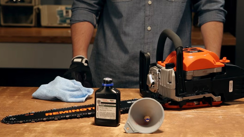 A shot of a Remington chainsaw and a container of bar oil