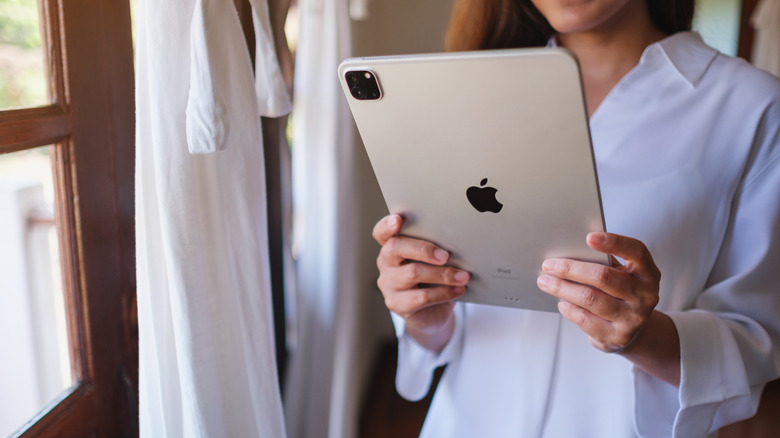 Woman holding an iPad with both her hands