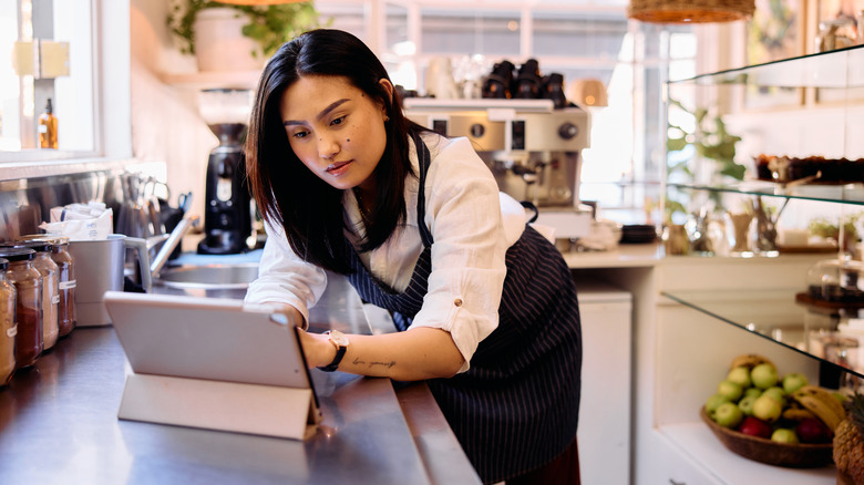 Woman using an iPad in a kitchen