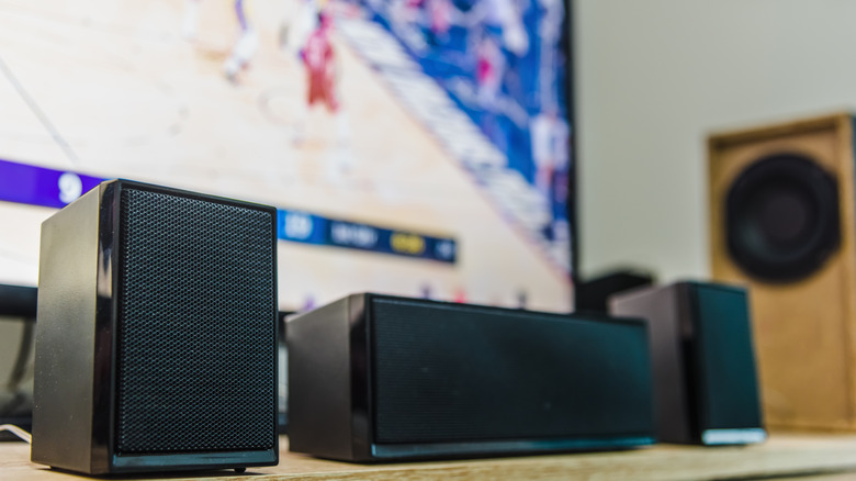 Pictures showing home theater speakers with sports on in the background