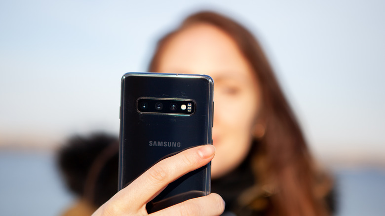 Girl taking selfie with Samsung phone