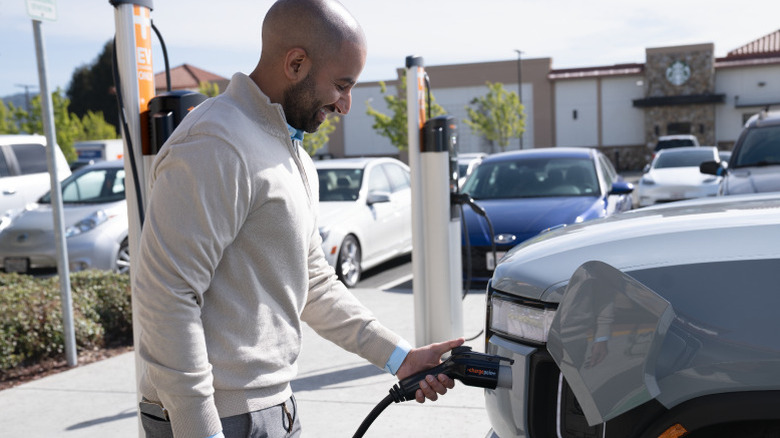 A man charging an EV at a ChargePoint station.