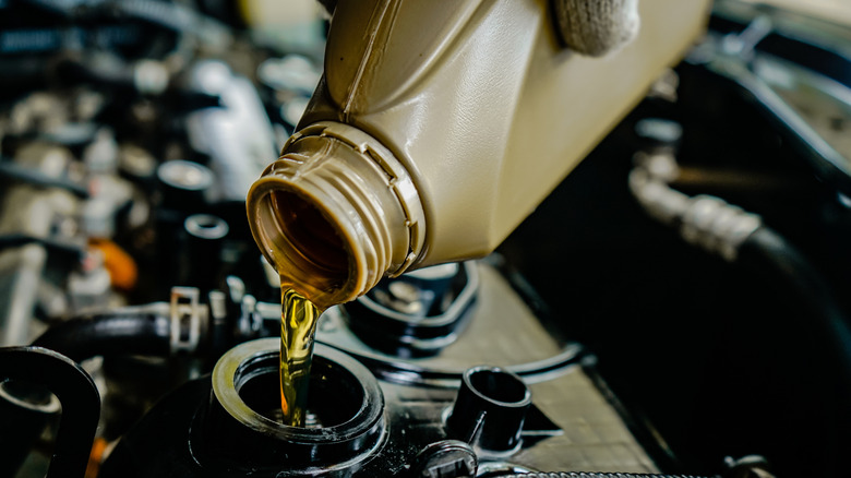 Close-up of motor oil being poured into an engine