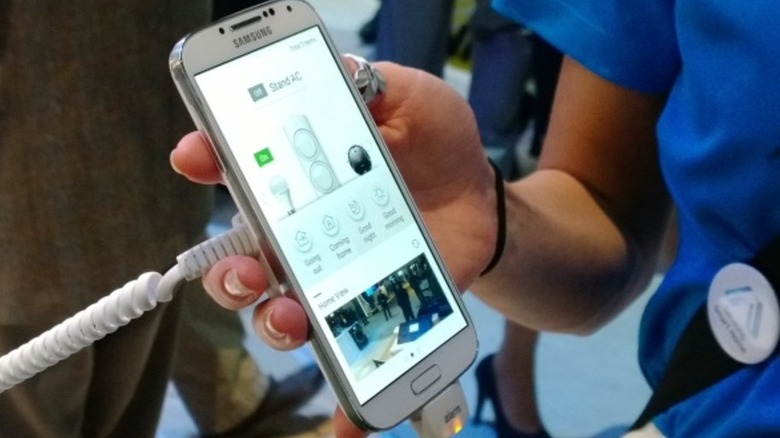 A person holding up a  smart phone and showing the camera for the store.