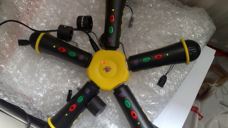 A bunch of microphones connected to a center charger.