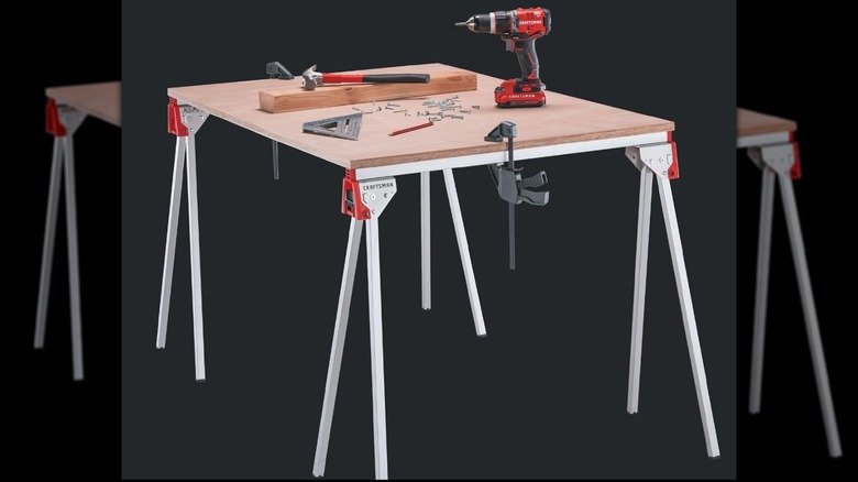 Craftsman Folding Metal Sawhorse holding wood and tools