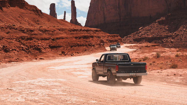Vintage pickup truck drives away in the desert