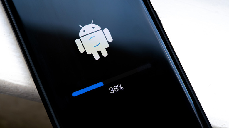 White Android logo positioned above a progress bar on a smartphone