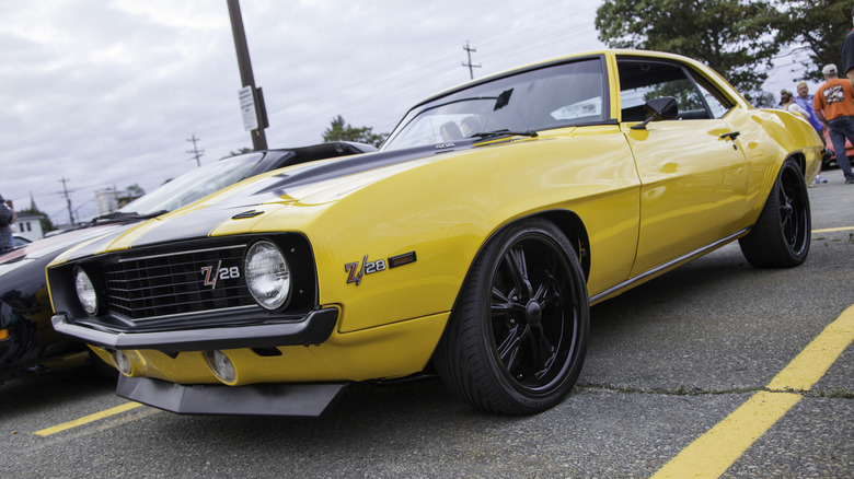 A yellow 1968 Chevrolet Camaro Z/28 parked on the street